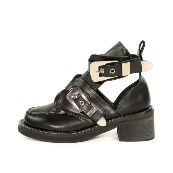 Black boot with gold-toned buckles. - Picture 1 of 3